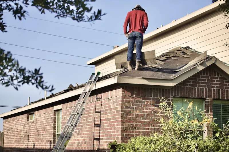 Professional roofer working on a residential roof in Lake Arbor